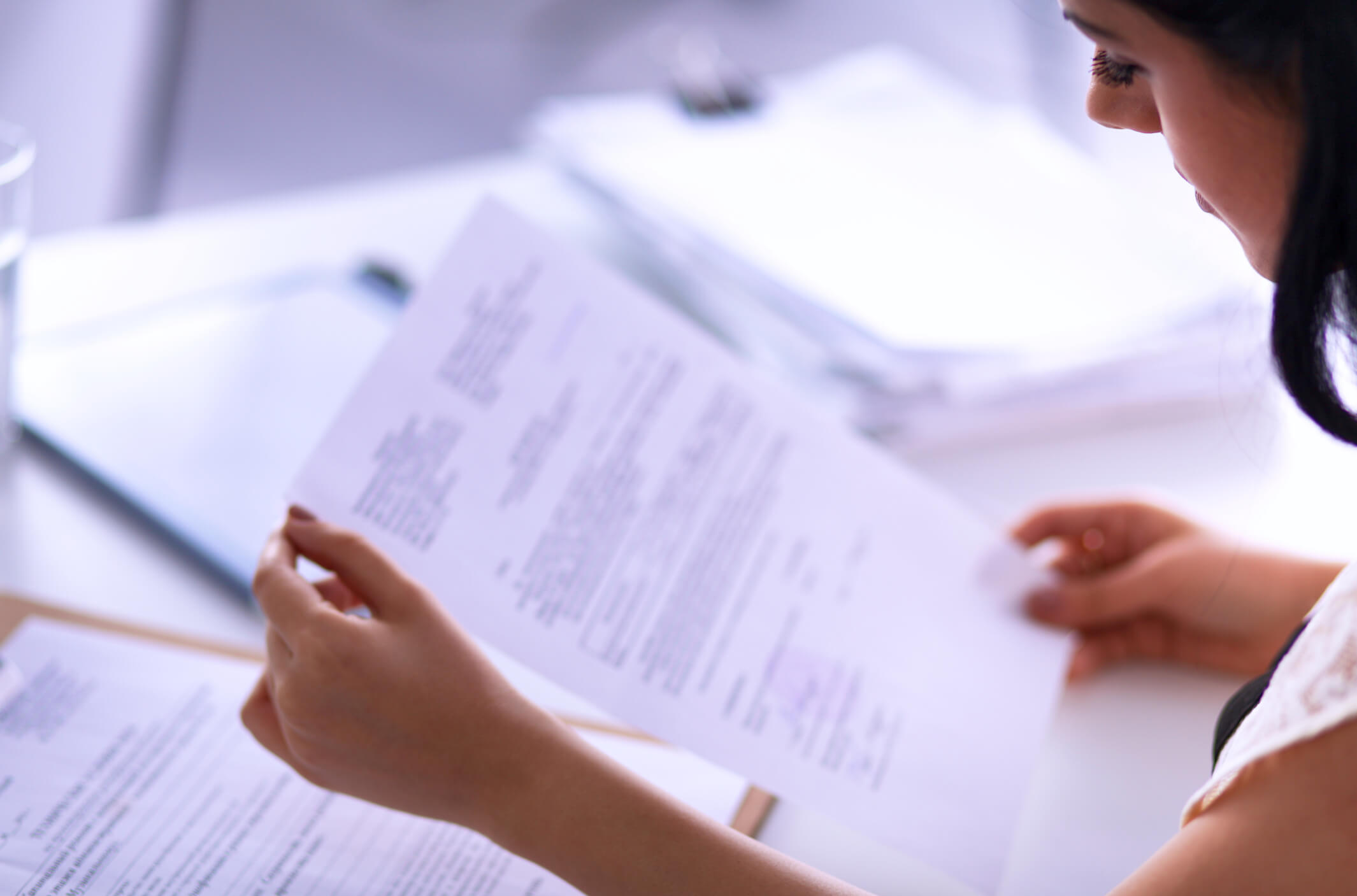 women's hand holding documents